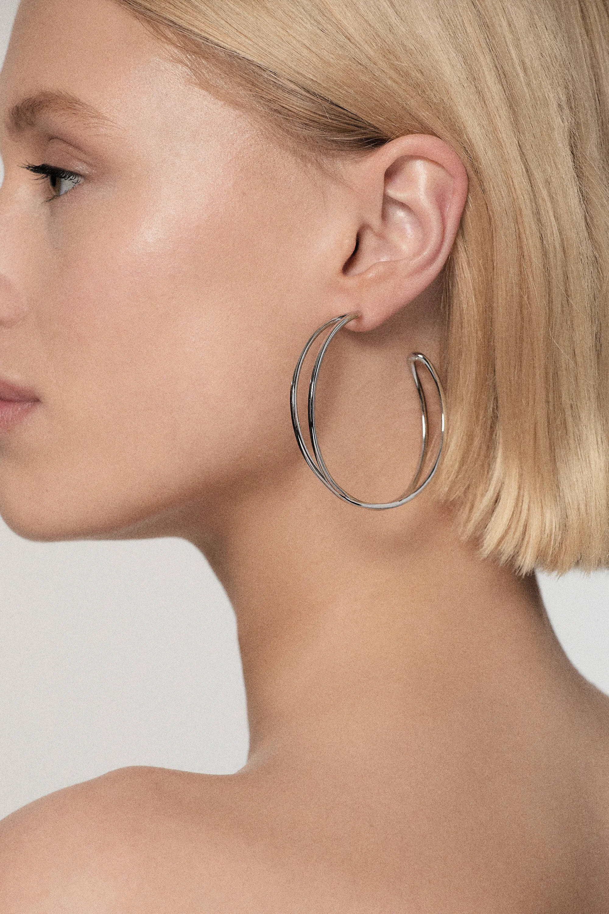 Silver Tone Criss Cross Hoop Earring BKK24079